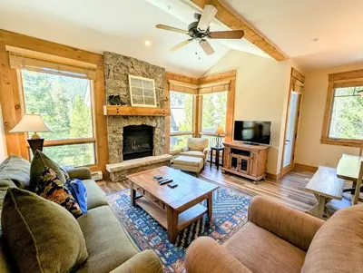 a living room with a couch and a fireplace at Settlers Creek 6521 by SummitCove Lodging in Keystone