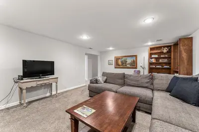 a living room with a couch and a tv at Modern Downtown Oasis Sunny Garden King Beds in Longmont