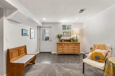 a living room with a couch and a chair and a table at Modern Downtown Oasis Sunny Garden King Beds in Longmont