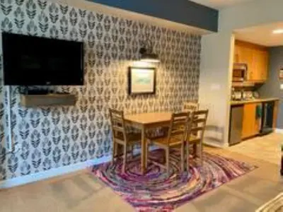 a dining room with a table and chairs and a tv at Fraser Crossing Top floor 3603 in Winter Park