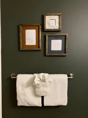 three framed pictures and towels hanging on a wall at Fraser Crossing Top floor 3603 in Winter Park