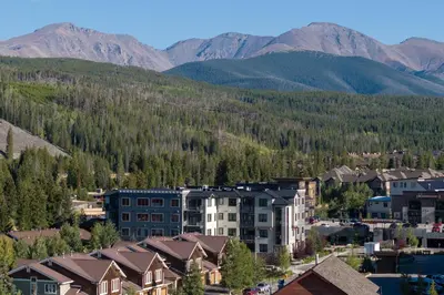 an aerial view of a town with mountains in the background at Downtown Flat condo in Winter Park