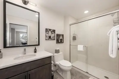 a bathroom with a toilet and a sink and a shower at Downtown Flat condo in Winter Park