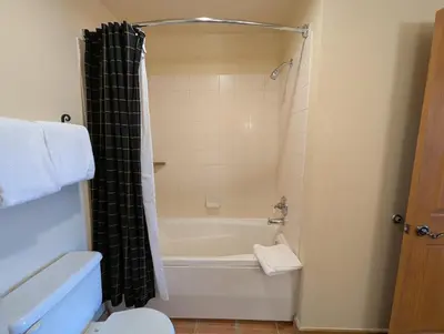 a bathroom with a tub and a toilet and a sink at Expedition Station 8634 by SummitCove Lodging in Keystone