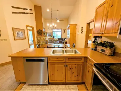 a kitchen with a sink and a stove top oven at Expedition Station 8634 by SummitCove Lodging in Keystone