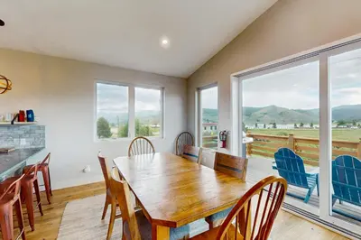 a dining room with a wooden table and chairs at Lance's Adventure Lodge in Tabernash