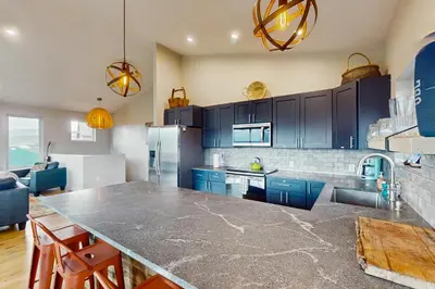 a kitchen with blue cabinets and a large counter top at Lance's Adventure Lodge in Tabernash