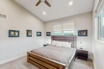 a bedroom with a large bed and a window at Lance's Adventure Lodge in Tabernash