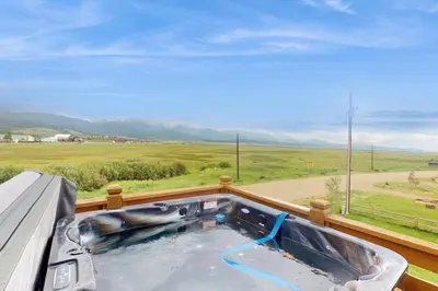 a hot tub on a balcony with a view at Lance's Adventure Lodge in Tabernash