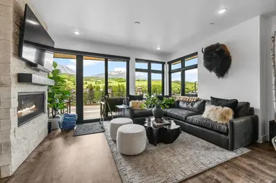 a living room with a couch and a fireplace at 4-Season Modern Mountain Penthouse with Private Hot Tub & Scenic Views in Silverthorne