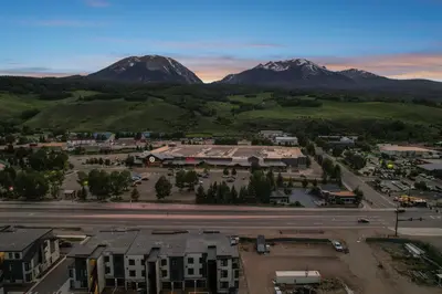 an aerial view of a town with mountains in the background at 4-Season Modern Mountain Penthouse with Private Hot Tub & Scenic Views in Silverthorne