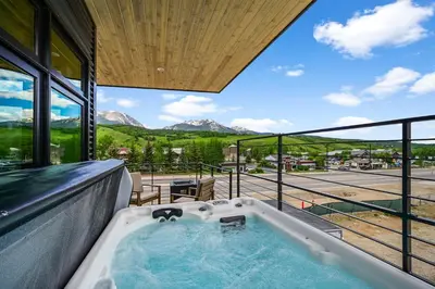 a jacuzzi tub in a house with a view at 4-Season Modern Mountain Penthouse with Private Hot Tub & Scenic Views in Silverthorne