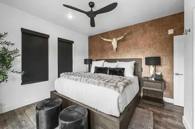 a bedroom with a large bed and a ceiling fan at 4-Season Modern Mountain Penthouse with Private Hot Tub & Scenic Views in Silverthorne