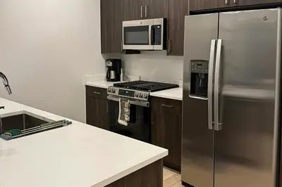 a kitchen with a stainless steel refrigerator and a microwave at Modern Mountain Nest in Silverthorne