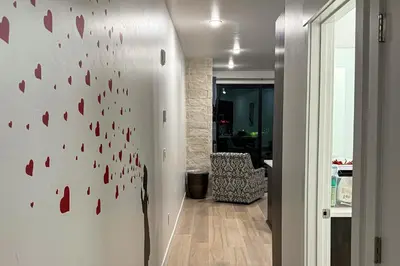 a hallway with a wall with red hearts on it at Modern Mountain Nest in Silverthorne