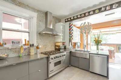 a kitchen with stainless steel appliances and a large window at Walk to Denver Zoo City Park Getaway with Garden in Denver