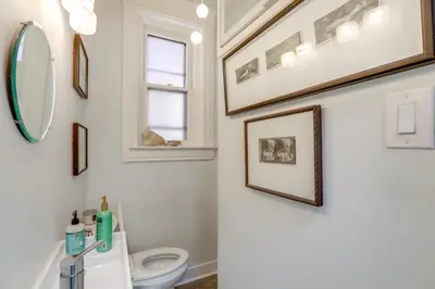 a bathroom with a toilet and a mirror at Walk to Denver Zoo City Park Getaway with Garden in Denver