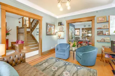 a living room with blue chairs and a staircase at Walk to Denver Zoo City Park Getaway with Garden in Denver
