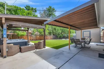a pavilion with a table and chairs on a patio at Cozy King suite- play room- hot tub in Denver