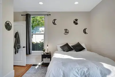 a bedroom with a white bed and a window at Longmont 2BD Comfort | Outdoor dining + Parking in Longmont