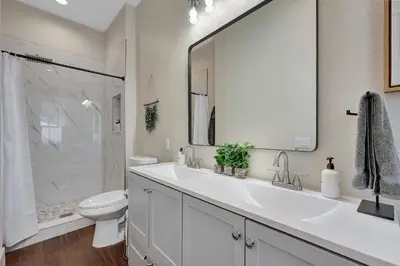 a white bathroom with a sink and a toilet at Longmont 2BD Comfort | Outdoor dining + Parking in Longmont