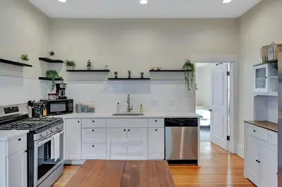 a kitchen with white cabinets and a stove at Longmont 2BD Comfort | Outdoor dining + Parking in Longmont