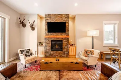 a living room with a fireplace and a tv at Winter Park Getaway 4 BR Townhouse w Hot Tub in Fraser