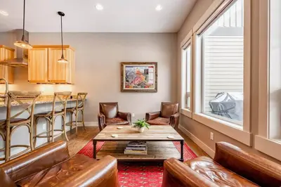 a living room with a table and chairs and a bar at Winter Park Getaway 4 BR Townhouse w Hot Tub in Fraser
