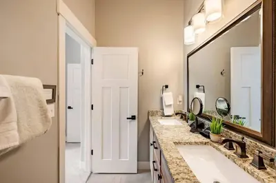 a bathroom with two sinks and a large mirror at Winter Park Getaway 4 BR Townhouse w Hot Tub in Fraser