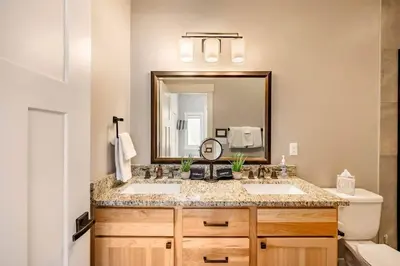 a bathroom with two sinks and a mirror at Winter Park Getaway 4 BR Townhouse w Hot Tub in Fraser