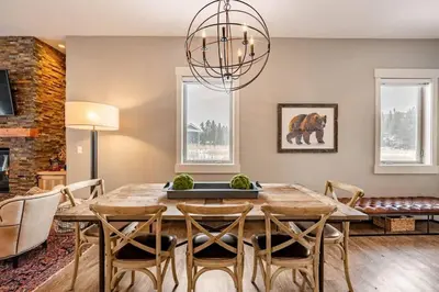 a dining room with a wooden table and chairs at Winter Park Getaway 4 BR Townhouse w Hot Tub in Fraser