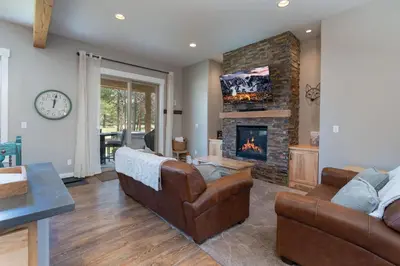 a living room with a couch and a fireplace at 4BR Fraser Getaway Hot Tub Sleeps 10 in Fraser