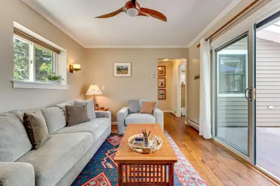a living room with a couch and a table at Private Hot Tub - Riverfront Cabin In Estes Park! in Estes Park