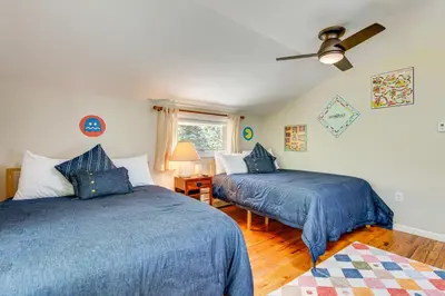 a bedroom with two beds and a ceiling fan at Private Hot Tub - Riverfront Cabin In Estes Park! in Estes Park