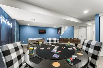 a dining room with a ping pong table and chairs at The Timberline- Game Room, Outdoor Theater, Bocce, Fire Pit, Pets in Arvada