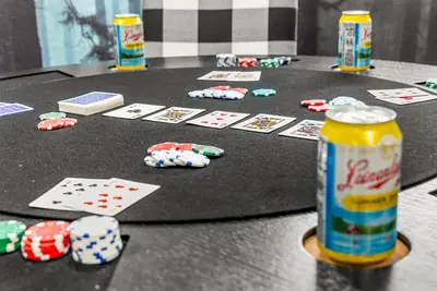 a table with poker cards and a can of soda at The Timberline- Game Room, Outdoor Theater, Bocce, Fire Pit, Pets in Arvada