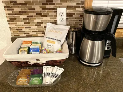 a counter with a coffee maker and a basket of food at Echo Hills Mountain Lodge - Evergreen Mountain Top Retreat - Foothills of the Rockies in Evergreen
