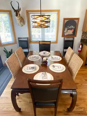 a dining room with a wooden table and chairs at Echo Hills Mountain Lodge - Evergreen Mountain Top Retreat - Foothills of the Rockies in Evergreen