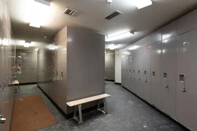 a row of lockers with a bench in a locker room at Fraser Crossing cabin in Winter Park