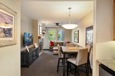 a dining room and living room with a table and chairs at Fraser Crossing cabin in Winter Park