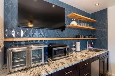 a kitchen with a counter top with a microwave at Modern Getaway with Private Balcony in Denver