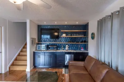 a living room with a couch and a kitchen at Modern Getaway with Private Balcony in Denver