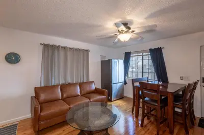 a living room with a couch and a table at Modern Getaway with Private Balcony in Denver