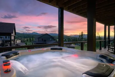 a hot tub on the balcony of a house at Aspen View Chalet home in Fraser