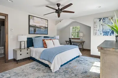 a bedroom with a bed and a ceiling fan at Aspen View Chalet home in Fraser