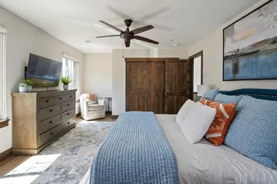 a bedroom with a bed and a flat screen tv at Aspen View Chalet home in Fraser