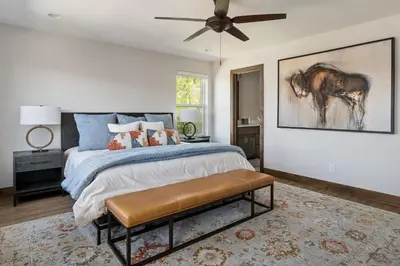a bedroom with a bed with a horse painting on the wall at Aspen View Chalet home in Fraser