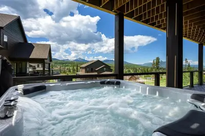 a jacuzzi tub with a view of the mountains at Aspen View Chalet home in Fraser