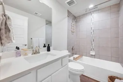 a white bathroom with a sink and a toilet at Luxe 6BD Gem in Johnstown -Tons of Games + Firepit in Johnstown