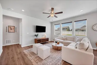 a living room with a couch and a ceiling fan at Luxe 6BD Gem in Johnstown -Tons of Games + Firepit in Johnstown